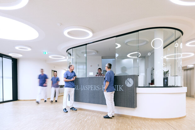 Klinikmitarbeitende an Rezeption